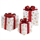 Set 3 Pacchi Regalo Natalizi Luminosi 25-20-15 cm con LED Bianco Caldo e USB Bianco e Oro con Fiocco Rosso      